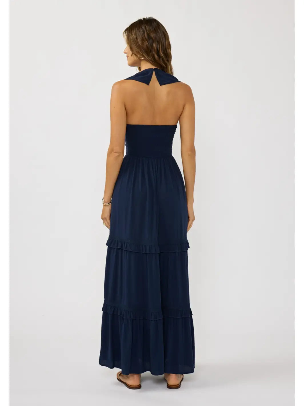 Back view of a flowy bohemian maxi dress featuring soft ruffle trims