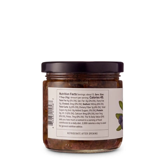 Jar of Black Olive Tapenade with a label showing nutrition facts on a white background