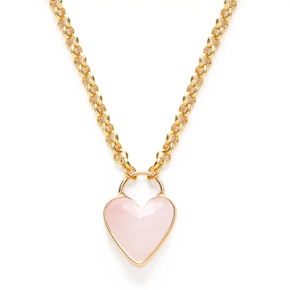 Gold necklace with a rose quartz heart pendant on a white background