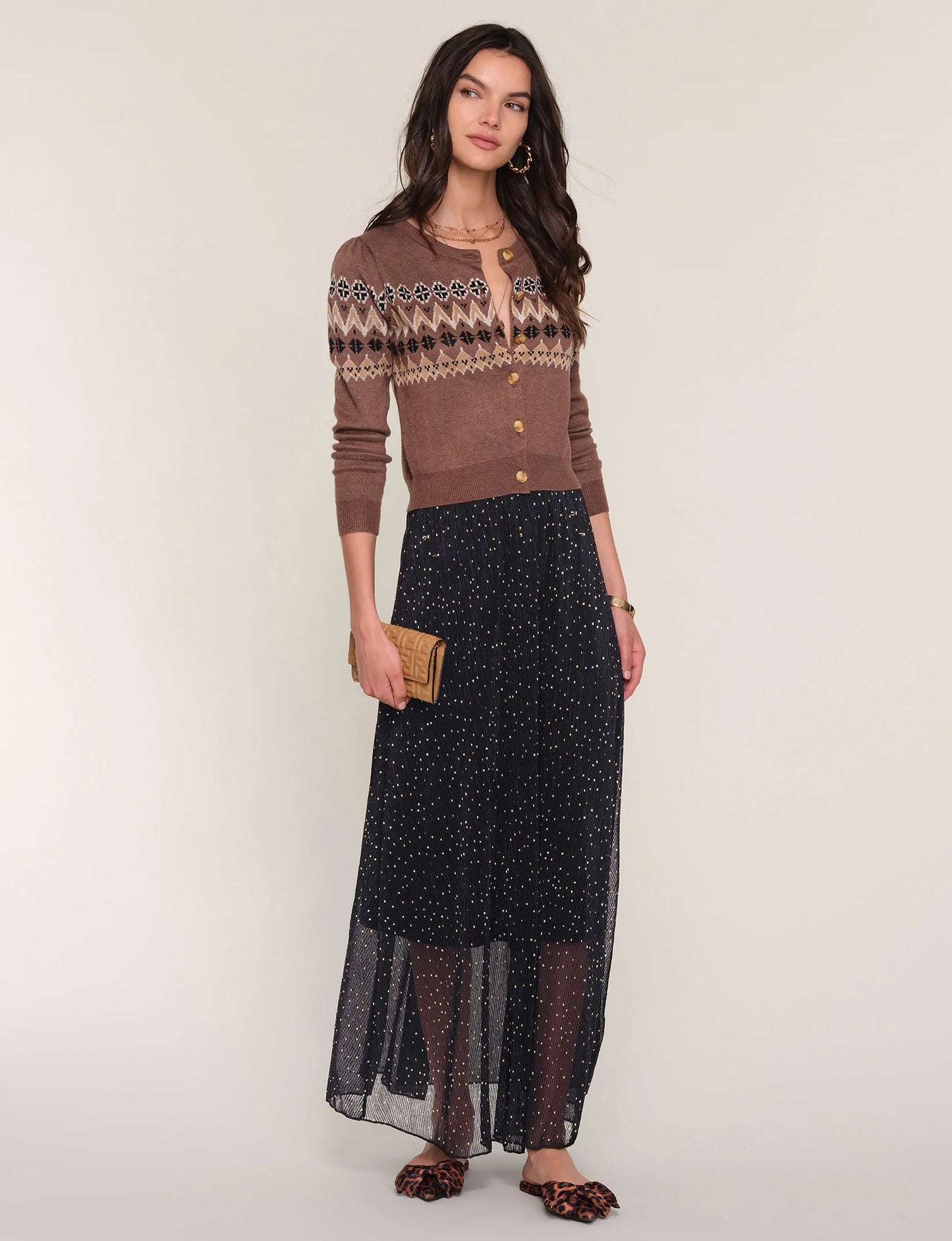 simple maxi skirt with an elastic waist. It showcases a sheer crinkled fabric with a delicate foil print throughout.
