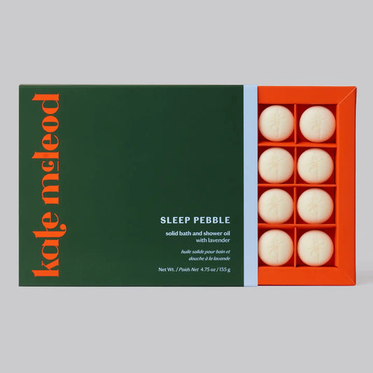 Box of Kate McLeod Sleep Pebble solid bath and shower oil with green label and orange packaging.