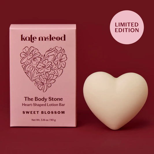 Heart-shaped lotion bar with packaging labeled on a red background