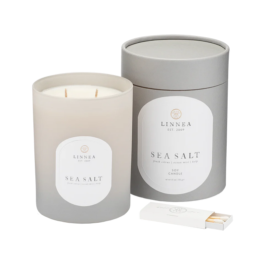 Sea Salt candle with packaging and lighter on a white background