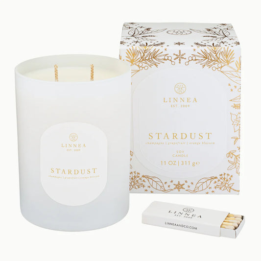 Stardust Candle Bright champagne bubbles rise into citrusy grapefruit and delicate orange blossom