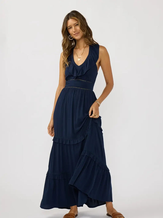 A flowy bohemian maxi dress featuring soft ruffle trims
