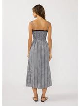 Load image into Gallery viewer, Back view of a woman wearing a black and white gingham checkered midi dress with spaghetti straps.