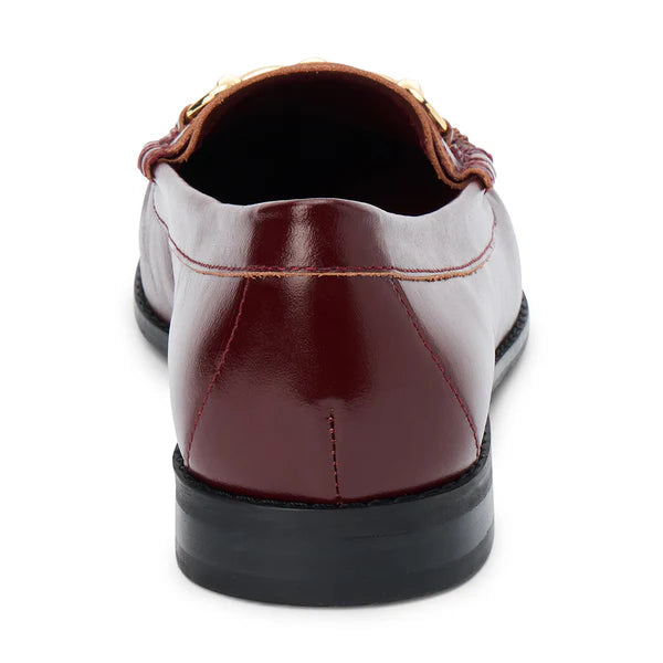 Burgundy leather loafer with gold chain detail on a white background