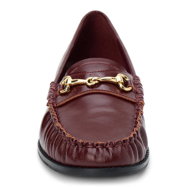 Burgundy leather loafer with gold chain detail on a white background