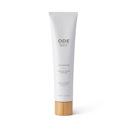 Tube of ODE unscented hand and body lotion with a wooden cap on a white background