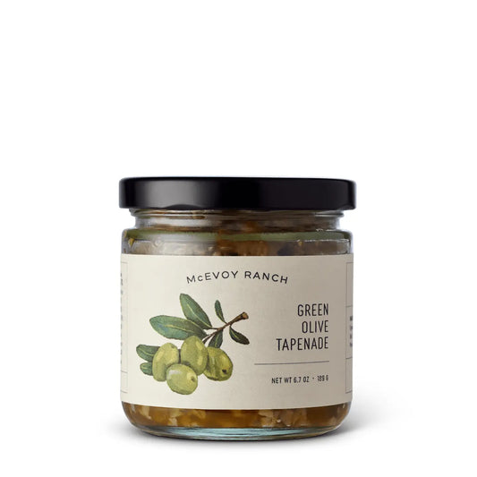 Jar of Green Olive Tapenade on a white background