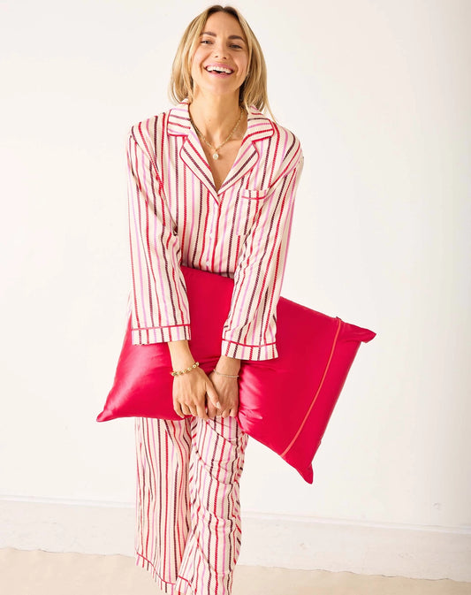 Woman wearing jewel-tone pajamas feature a swing top that provides a comfortable and flattering fit and elastic waist bottoms