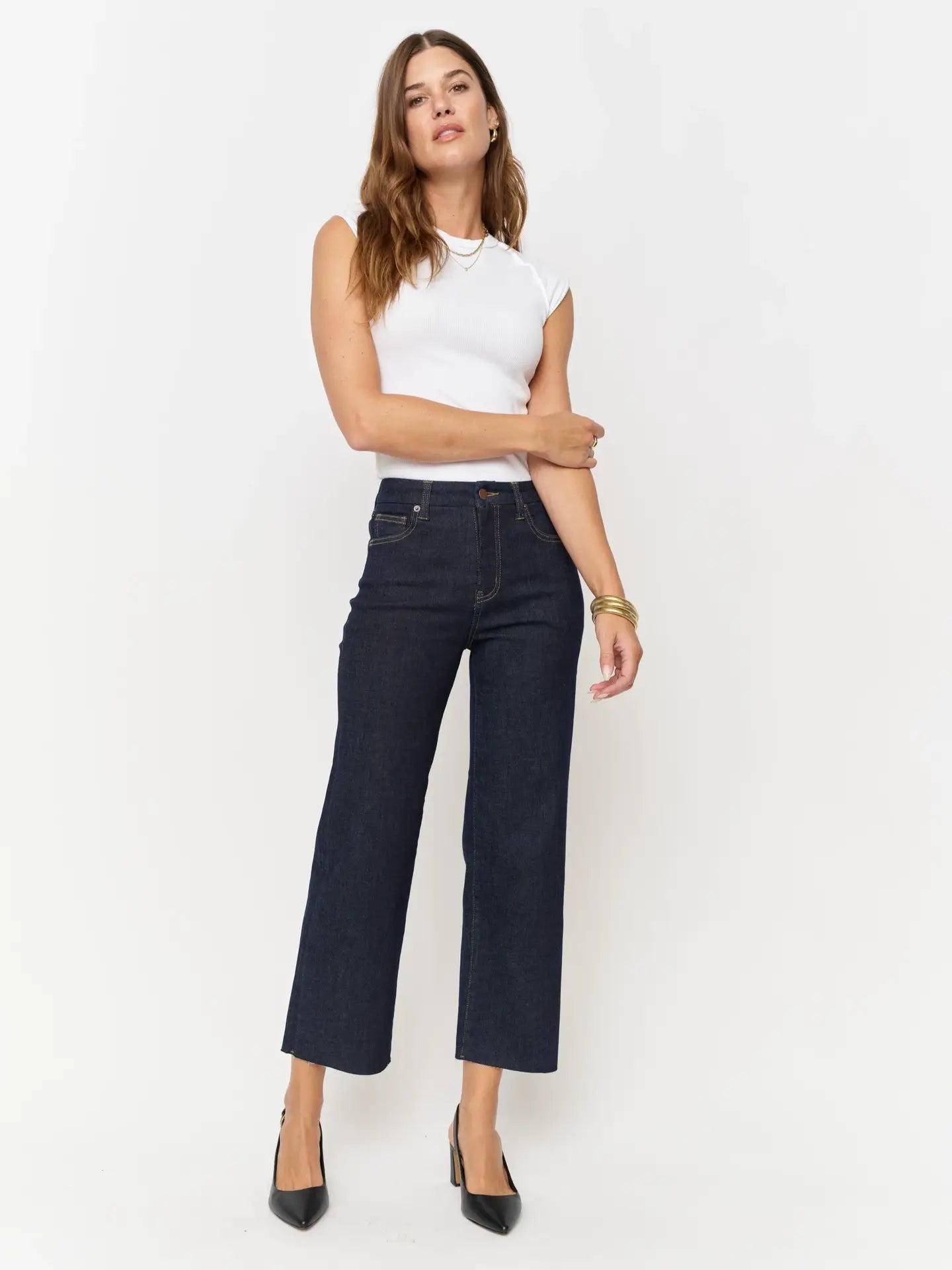 High-rise denim wide leg crop, fitted through the hip, zipper fly, and a cropped raw hem.