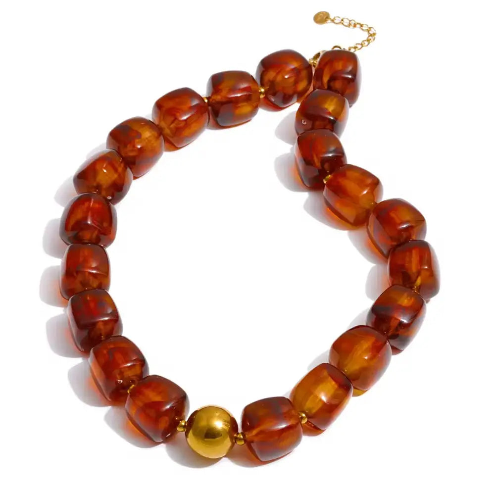 Brown beaded necklace with a gold clasp on a white background