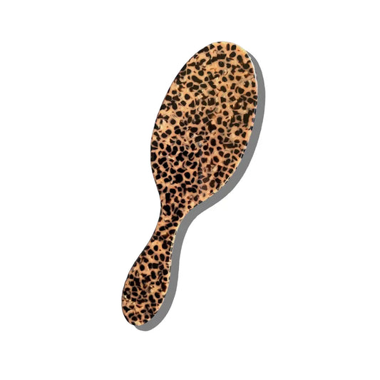 Hairbrush with a leopard print handle on a white background