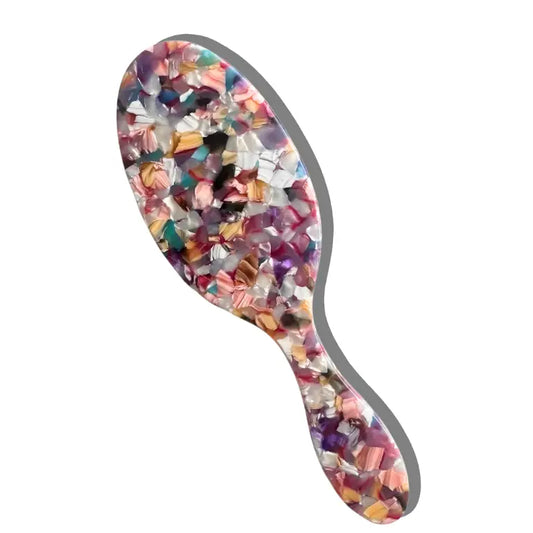 Multicolored hairbrush on a white background