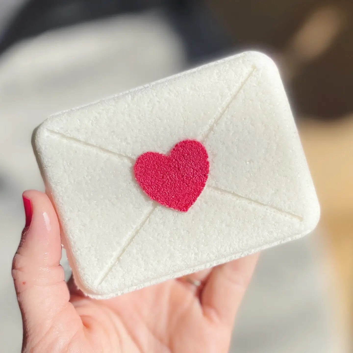 A very large bath bomb, filled with surprise colors inside and scented with champagne toast