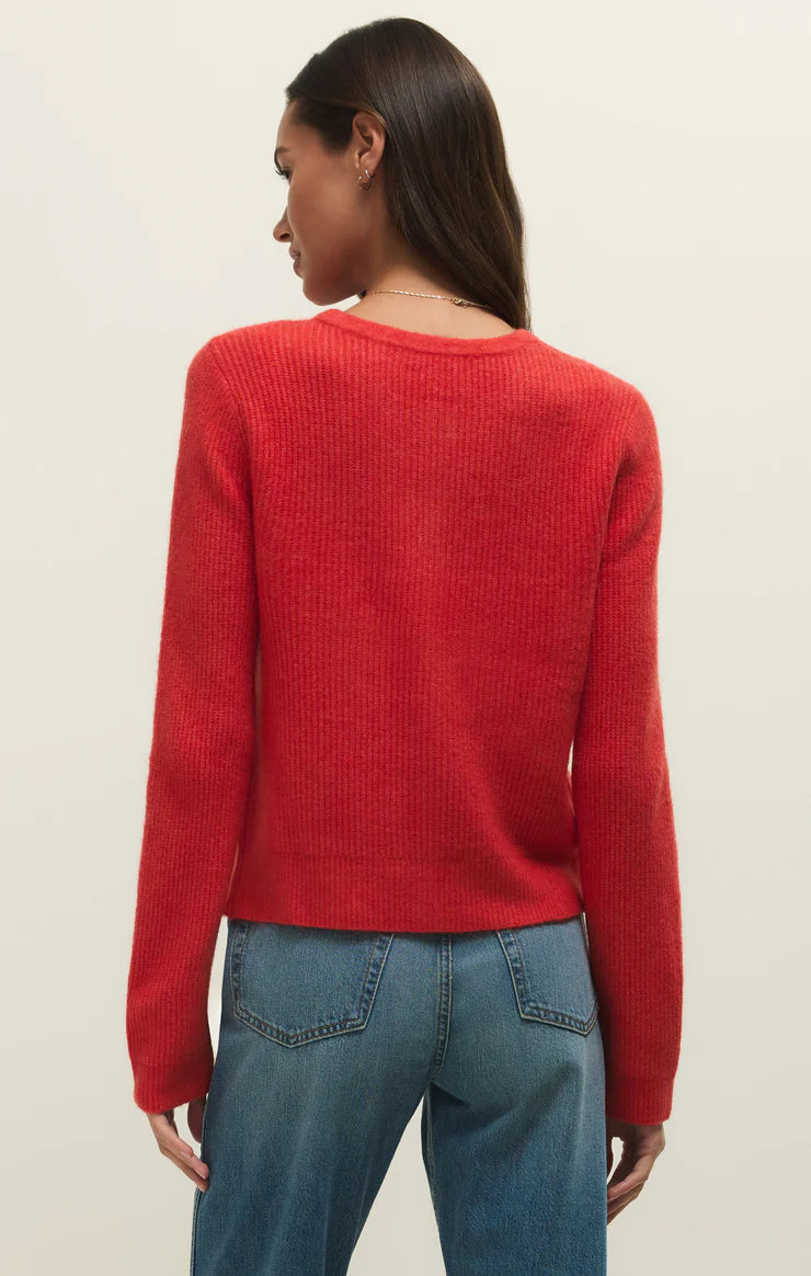 Back view of a woman wearing a red relaxed button up crewneck rib cardigan