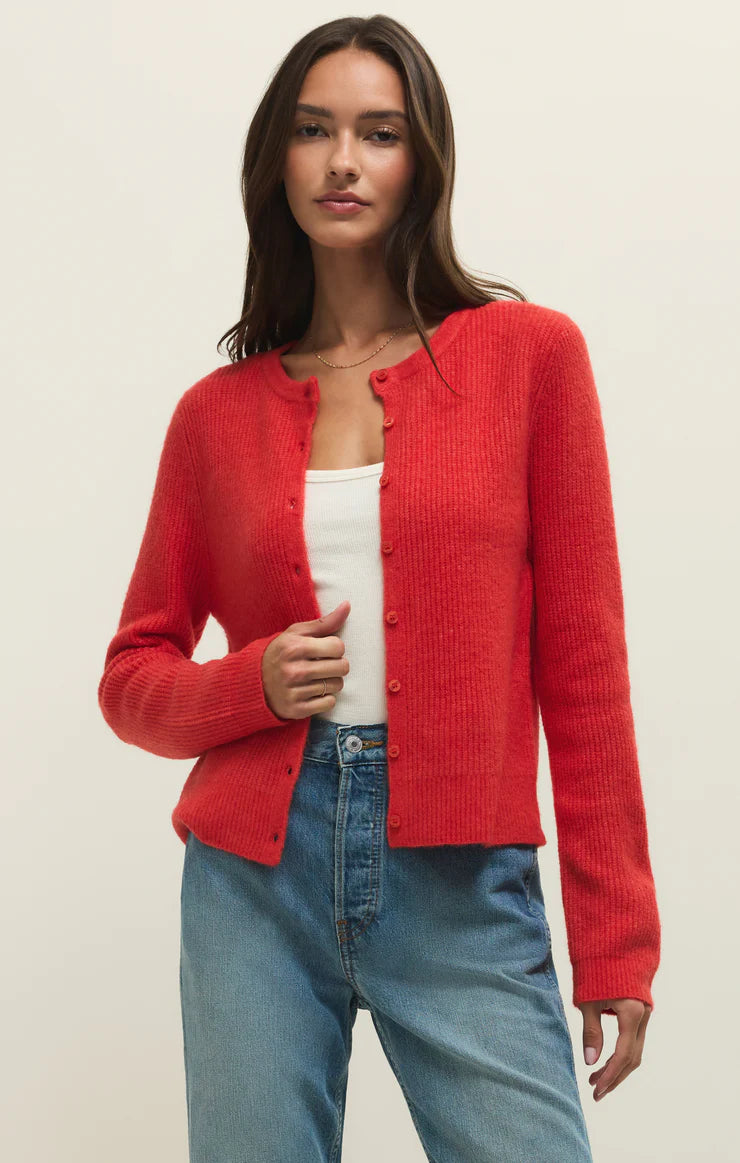 Woman wearing a red relaxed button up crewneck rib cardigan