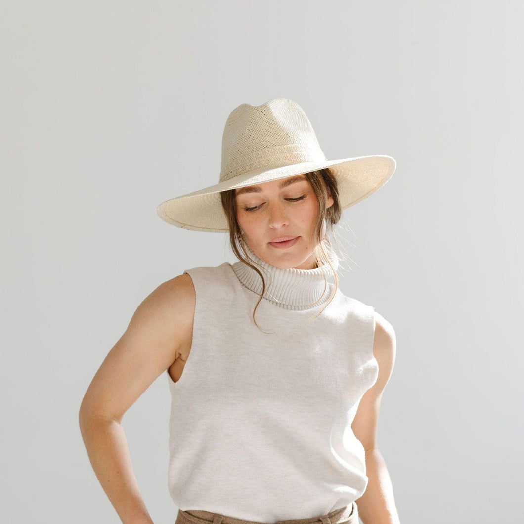 The Fiona is a straw fedora with a wide A-line brim featuring a complimenting straw band. 